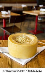 Italian Spaghetti Pasta Cooked Inside A Giant Parmesan Cheese Wheel