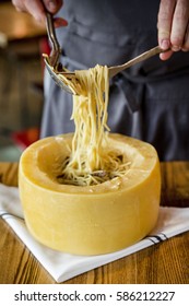 Italian Spaghetti Pasta Cooked Inside A Giant Parmesan Cheese Wheel