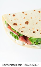 Italian Street Food Flat Lay With Piadina Isolated On A White Background.  Piadina Romagnola - Italian Flatbread With Prosciutto, Salad And Cream Cheese