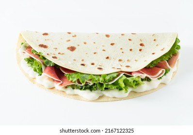 Italian Street Food Flat Lay With Piadina Isolated On A White Background.  Piadina Romagnola - Italian Flatbread With Prosciutto, Salad And Cream Cheese