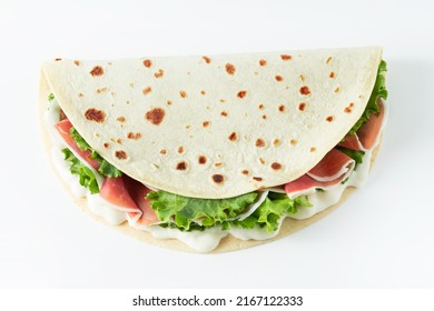 Italian Street Food Flat Lay With Piadina Isolated On A White Background.  Piadina Romagnola - Italian Flatbread With Prosciutto, Salad And Cream Cheese