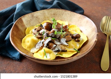 Italian stuffed pasta ravioli with mushroom sauce