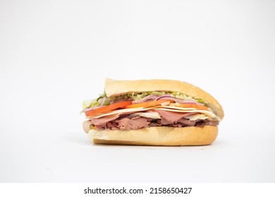 An Italian Sub Sandwich Portraying All Of Its Ingredients On A White Background