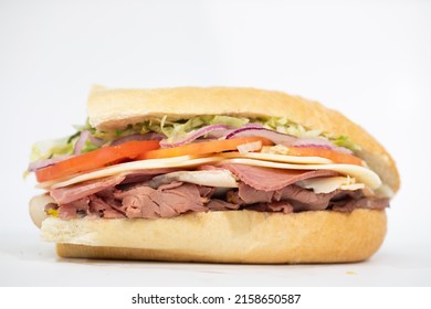 An Italian Sub Sandwich Portraying All Of Its Ingredients On A White Background