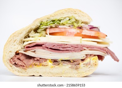 An Italian Sub Sandwich Portraying All Of Its Ingredients On A White Background