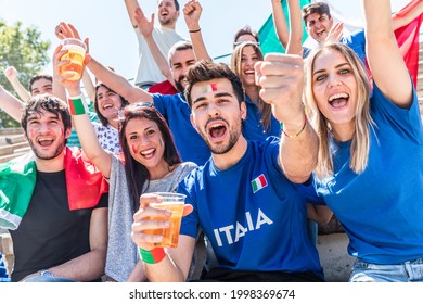 Italian Supporters Celebrating At Stadium With Flags - Group Of Fans Watching A Match And Cheering Team Italy - Sport And Lifestyle Concepts