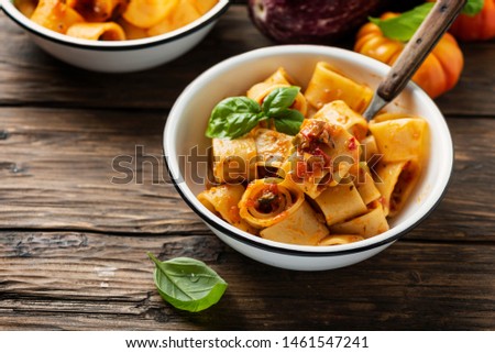 Italian tupe of pasta calamarata with vegetarian sauce, rustica style and selective focus