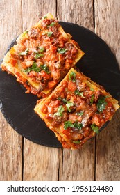 Italian Vincisgrassi Or Vincesgrassi, Is A Typical Marche Pasta Dish Similar To Lasagne Al Forno Closeup In The Slate Board On The Table. Vertical Top View From Above
