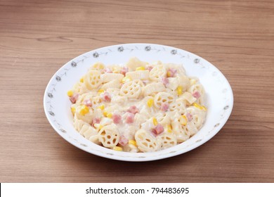 Italian wagon wheel shape pasta with ham and corn - Powered by Shutterstock