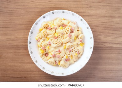 Italian wagon wheel shape pasta with ham and corn - Powered by Shutterstock