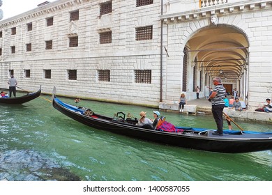 Italy - 21 June 2018: Romantic Couple Crusing On Local Traditional Gondola Boat Near Grand Canal Surround By Vintage Building In Venice Italy