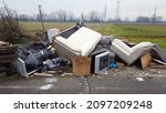 Italy, December 2021 Illegal open-air waste dump near Milan city downtown  ( Vaiano Valle ) - tons of garbage waste, polluting plastics abandoned in nature - environmental sustainability and mafia