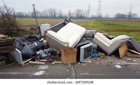 Italy, December 2021 Illegal open-air waste dump near Milan city downtown  ( Vaiano Valle ) - tons of garbage waste, polluting plastics abandoned in nature - environmental sustainability and mafia - Shutterstock ID 2097209248