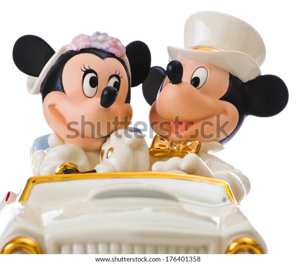 ITALY - FEBRUARY 12, 2014: Minnie's Dream honeymoon Disney, wedding cake topper by Lenox. The object is in porcelain 24 karat gold. Mickey Mouse and Minnie Mouse in the car are leaving for honeymoon.