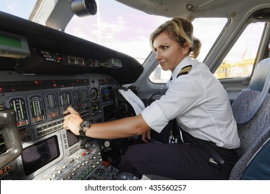Italy, female pilot in an airplane's cockpit