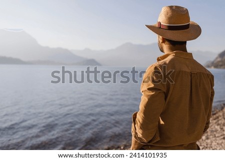 Italy- lierna- back view of man looking at lake