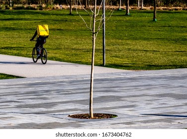 Italy, Milan, March 2020, Runners Bring Groceries Home During The Quarantine Period In The Citylife District In Milan. Quarantine Caused By COVID19, Coronavirus.