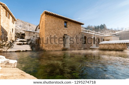 Italy, Rasiglia in winter , central pool with water vapor in Rasiglia, medieval city in central Italy, where water flows in streams inside the city.