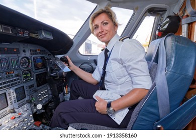 Italy, Rome, Ciampino International Airport; 26 July 2010, female pilot in the cockpit of an airplane on the runway - EDITORIAL