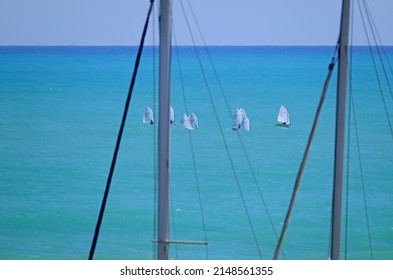 Italy, Siciliy, Mediterranean sea, Marina di Ragusa; 22 April 2022, sailing boat  masts in the port and ‎sailing dinghies - EDITORIAL