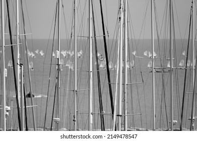 Italy, Siciliy, Mediterranean sea, Marina di Ragusa; 25 April 2022, sailing boat  masts in the marina and ‎sailing dinghies race - EDITORIAL