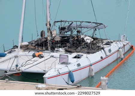Italy, Sicily, Mediterranean sea, Marina di Ragusa (Ragusa Province); sailing boat wreck fire burned in the port 