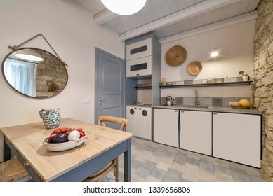 Italy, Sicily, Ragusa Province, countryside; 1 August 2015, elegant private house, view of the kitchen and a wooden dining table - EDITORIAL - Shutterstock ID 1339656806