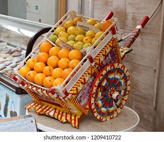 Italy, Sicily, Trapani.Miniature of Sicilian cart with citrus fruits.