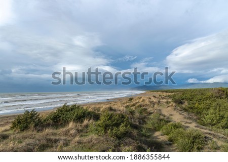 Italy Tuscany Maremma Grosseto, Marina di Grosseto beach, view of the stormy sea, Castiglione della Pescaia in the background