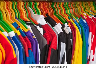 Italy, Tuscany, Pisa. Men's Colorful Shirts Hanging On Colorful Hangers Along A Street Market In The City Of Pisa.