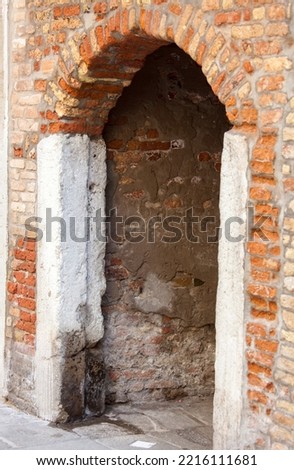 Italy, Venice. Old brick archway along the streets of Venice.