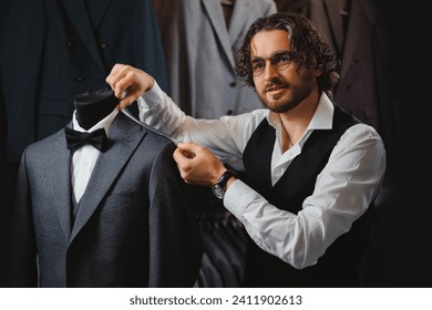 Italy young man tailor fitting bespoke suit to men in atelier or tailoring studio. Concept fashion dressmaker handmade couturier. - Powered by Shutterstock