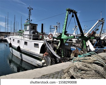 Italy,Civitavecchia, November 12,2019 fishing boats moored after a night at sea - Shutterstock ID 1558290008