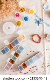 Items for beading - boxes with beads, thread and scissors on the table. Creative leisure, home teaching crafts for children. Top  and vertical view.