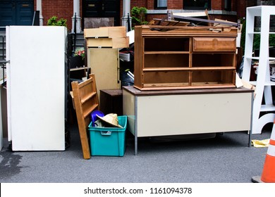 Items And Old Furniture On Street Outside House Moving Day Or Getting Rid Of Junk And Household Storage Concept