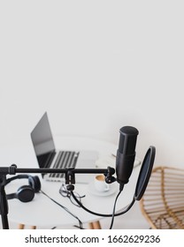 Items For Recording Podcast: Professional Microphone, Earphones And Laptop On White Table In Cozy Home Studio. Place For Text. Copy Space.