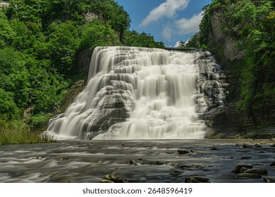 Ithaca Falls cascades dramatically down the rock formation from Fall Creek into Cayuga Lake in Ithaca, New York, USA