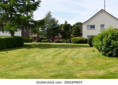 Itzehoe, Germany - Jun 2010: View Of Green Lawn In Backyard Of House In Neighborhood In Summer With Trees And Clouds In Blue Sky Background. No People. 