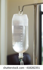 IV Bag Hanging On A Metal Pole In The Room