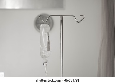 IV Bag Hanging On A Metal Pole In The Hospital Room