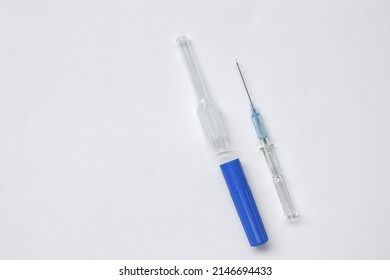 IV Catheter With A Needle Sheath Placed On White Background. 

