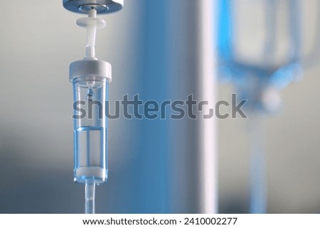 IV drip against blurred background, space for text