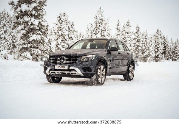 IVALO, FINLAND - January 28, 2016: Winter tire test\
is held at the proving ground. Test-driver performs a handling test\
on Mercedes-Benz GLC to determine the tire which provides the best\
grip on snow.