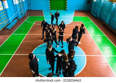 Ivano-Frankivsk, Ukraine May 15, 2021: Photo Of Students Lying On The Floor In The Gym, Top View, Students In Black Clothes, Drone Photo.