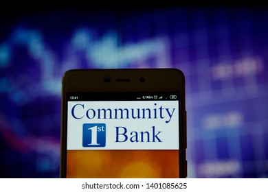 Ivano-Frankivsk, Ukraine - May 16, 2019:  Community 1st Bank Las Vegas Logo Is Seen On An Smartphone Over Over Stock Chart.  Community 1st Bank Las Vegas Logo Is Displayed On The Screen