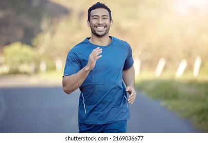 Ive Always Been One To Chase My Dreams. Shot Of A Handsome Young Man Running Alone Outside During The Day.