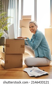 Ive Got All My Ducks In A Row. Portrait Of A Mature Woman Using A Laptop On Moving Day.