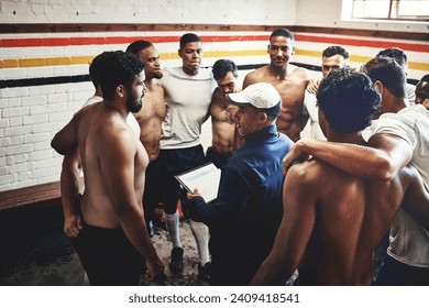 Ive the plan considering our next game. Cropped shot of a rugby coach addressing his team players in a locker room during the day. - Powered by Shutterstock