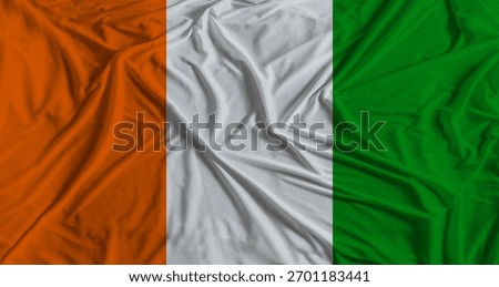 Ivorian flag with fabric texture background. National flag of Ivory Coast with cloth texture