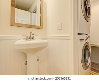 Ivory Bathroom With Laundry Area. View Of White Washbasin Stand